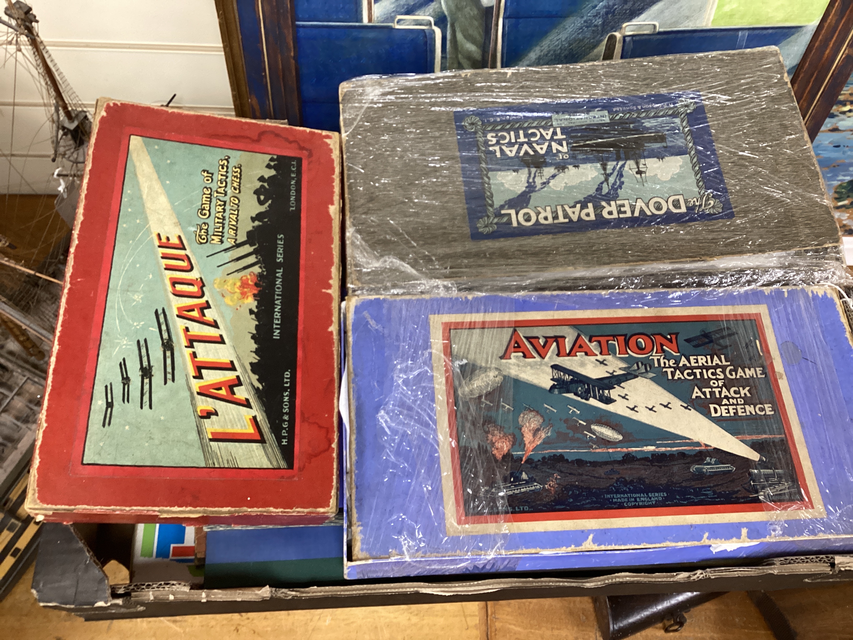 A collection of tinplate toys including cars, a fire engine, a Firebird jet plane, a Tri-ang lifeboat, an Tri-ang Minic tractor, etc. (11), together with a box of boardgames including Vintage Gibson and others; Bandit Ch